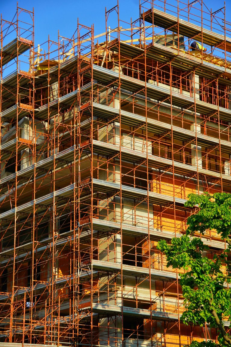 Scaffolded building under construction on a sunny day